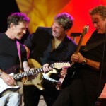 Mick Dallavee having a good time on stage with Bruce Greenwood, and Don Felder.
